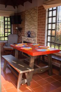 a wooden table in a room with a brick wall at Cabaña Campestre El Refugio in Paipa