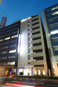 a tall building with a clock on the side of it at Dormy Inn Express Matsue in Matsue