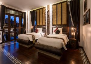 Giường trong phòng chung tại Khmer Paradise Villa
