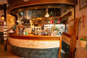 a bar in a restaurant with a large wooden barrel at YHA Boggle Hole in Fylingthorpe