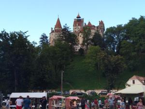 a castle on top of a hill with a crowd of people at Casa Vera in Bran