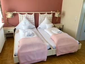 a bed with two pillows on it in a room at Haus Schneekappe (Winterberg) in Winterberg
