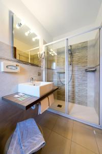 a bathroom with a sink and a shower at Hotel Vallecetta in Bormio