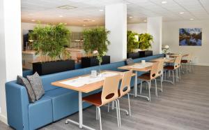 a row of tables and chairs in a restaurant at Hotell Fritidsparken in Skien