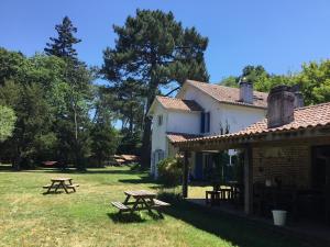 a building with picnic tables in the grass at Gites-Cyclistes-Léon in Léon