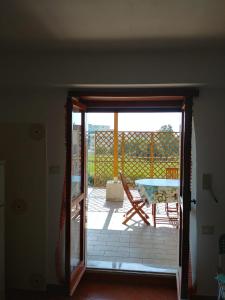 una porta aperta su un patio con tavolo e tavolo di Casa dei Girasoli - Formia centro a Formia