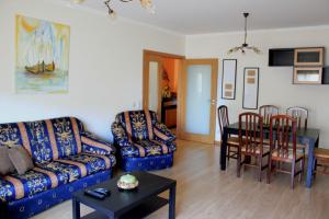 a living room with a couch and a table and chairs at Sweet Dream House in Faro