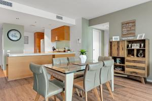 a kitchen and dining room with a table and chairs at Docklands Private Collection - NEWQUAY in Melbourne