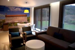a living room with a couch and chairs and a table at Apartamentos Rurales Las Vegas de Cardeo in Las Vegas De Cardeo