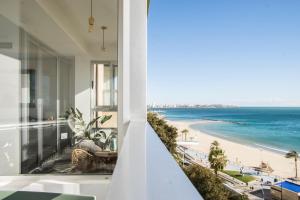 a view of the beach from the balcony of a house at Alicante Ocean View in Alicante