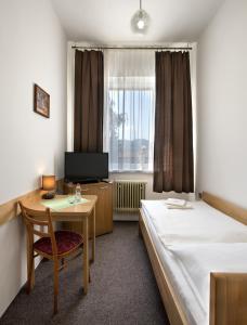 Posteľ alebo postele v izbe v ubytovaní Penzión Centrál