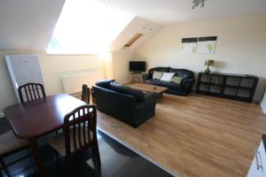 a living room with a couch and a table at MARLEY MANSIONs APARTMENTS - KING ST REF : 10/3 in Wallasey