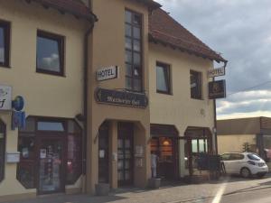 a building on the side of a street at Hotel Maxdorfer Hof in Maxdorf