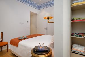a white bedroom with a bed and a table at Once Upon Lisboa Family Units in Lisbon