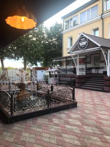 a building with a fountain in front of it at Gostiniy Dvorik Guest House in Yaroslavl