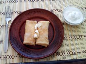 a brown plate with two pieces of food on a table at motel Pid Strihoyu in Kremenchuk