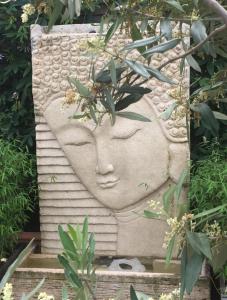 a stone statue of a head in a garden at Blaine's: A B&B and private dining.... in Amsterdam