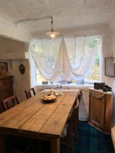 a dining room with a wooden table and a large window at Dreamton Village in Kameoka +57 photos