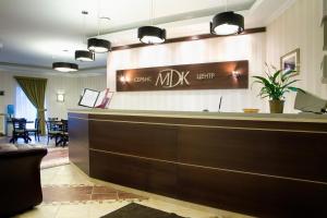 a hotel lobby with a reception desk and a waiting area at MDK Hotel in Saint Petersburg