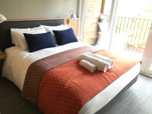 a bedroom with a bed with two towels on it at West Court- Jesus College in Cambridge