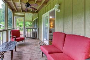 a living room with a couch and chairs on a porch at Laurel Lodge at Mountain Cove in Fort Smith