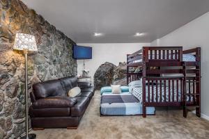 a living room with a couch and a rock wall at The Treehouse in Munds Park