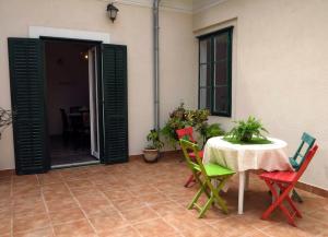 a patio with a table and chairs and a room at Villa Nada in Zadar