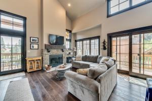 a living room with a couch and a fireplace at Tamarack Townhouse in Donnelly