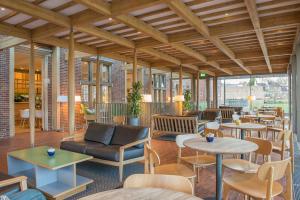 a lobby with tables and couches and chairs at West Court- Jesus College in Cambridge
