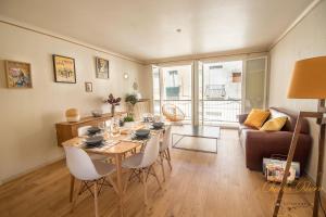 a living room with a table and a couch at Chez Emy in Sète