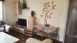 a living room with a table and a tv at Achill Houses in Thika