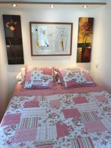 ein Schlafzimmer mit einem Bett mit einer rosa Decke darauf in der Unterkunft Le Vénitien in Arles