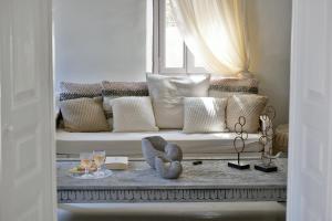 a living room with a couch with a window at ALIA MANSION by K&K in Megalochori