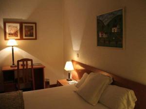 a hotel room with a bed with two pillows at Hostal Gran Via Levante in Torrevieja