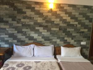 A bed or beds in a room at Lake Vision Guesthouse
