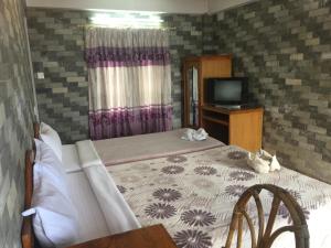 A bed or beds in a room at Lake Vision Guesthouse