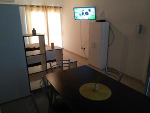 a dining room with a table and a tv on the wall at Departamento Andino del Sol in San Juan