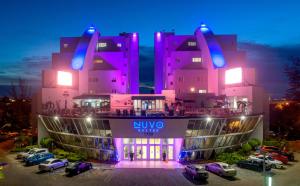 a large building with a clock on the front of it at Nuvo Suites Hotel - Miami / Doral in Miami