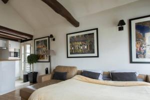 a living room with a bed and a couch at Luxurious Duplex - Top of Montmartre in Paris