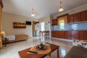 a living room with a couch and a table at Anna Apartments in Chrysi Ammoudia