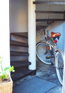 a bike is parked next to a staircase at Eagle’s Nest Hostel in Postojna