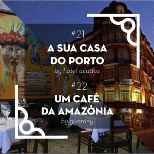 um sinal para um restaurante em frente a um edifício em Hotel Aliados em Porto