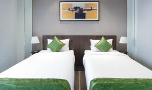 Treebo Elite Residency Belgaum客房内的一张或多张床位