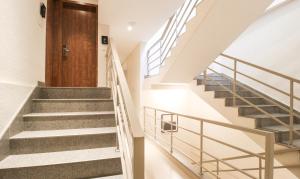 贝尔高姆Treebo Elite Residency Belgaum的一栋有木门的房子里的楼梯