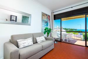 un soggiorno con divano e balcone di WHome | Albufeira Suite & Beach Apartment ad Albufeira