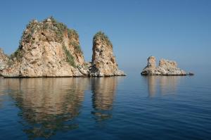 a group of rocks in the water at Torre Bennistra in Scopello