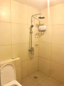a bathroom with a shower and a toilet in it at Cedar Peak Condominium in Baguio