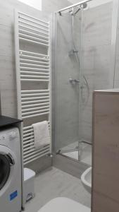a bathroom with a shower and a toilet and a sink at CA' VEGIA in Gravedona +7 photos