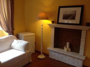 een woonkamer met een open haard en een bed en een lamp bij La Casina del Borgo in Abbadia San Salvatore