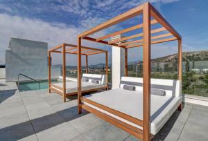 two beds on a balcony with a pool at Hoposa Pollentia - Adults Only in Port de Pollensa